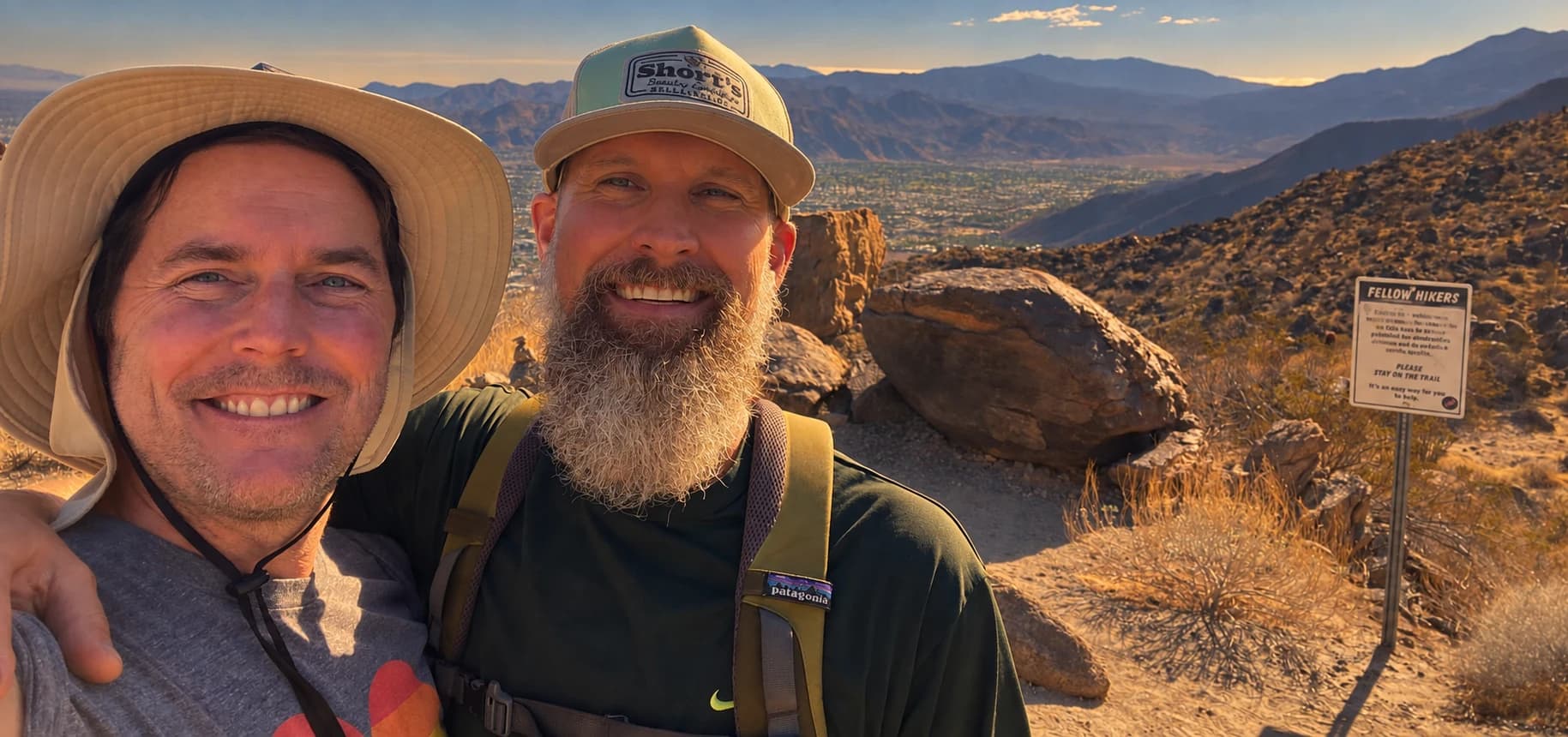 Todd Adams and Frank Naugo on a desert trail, the valley behind them